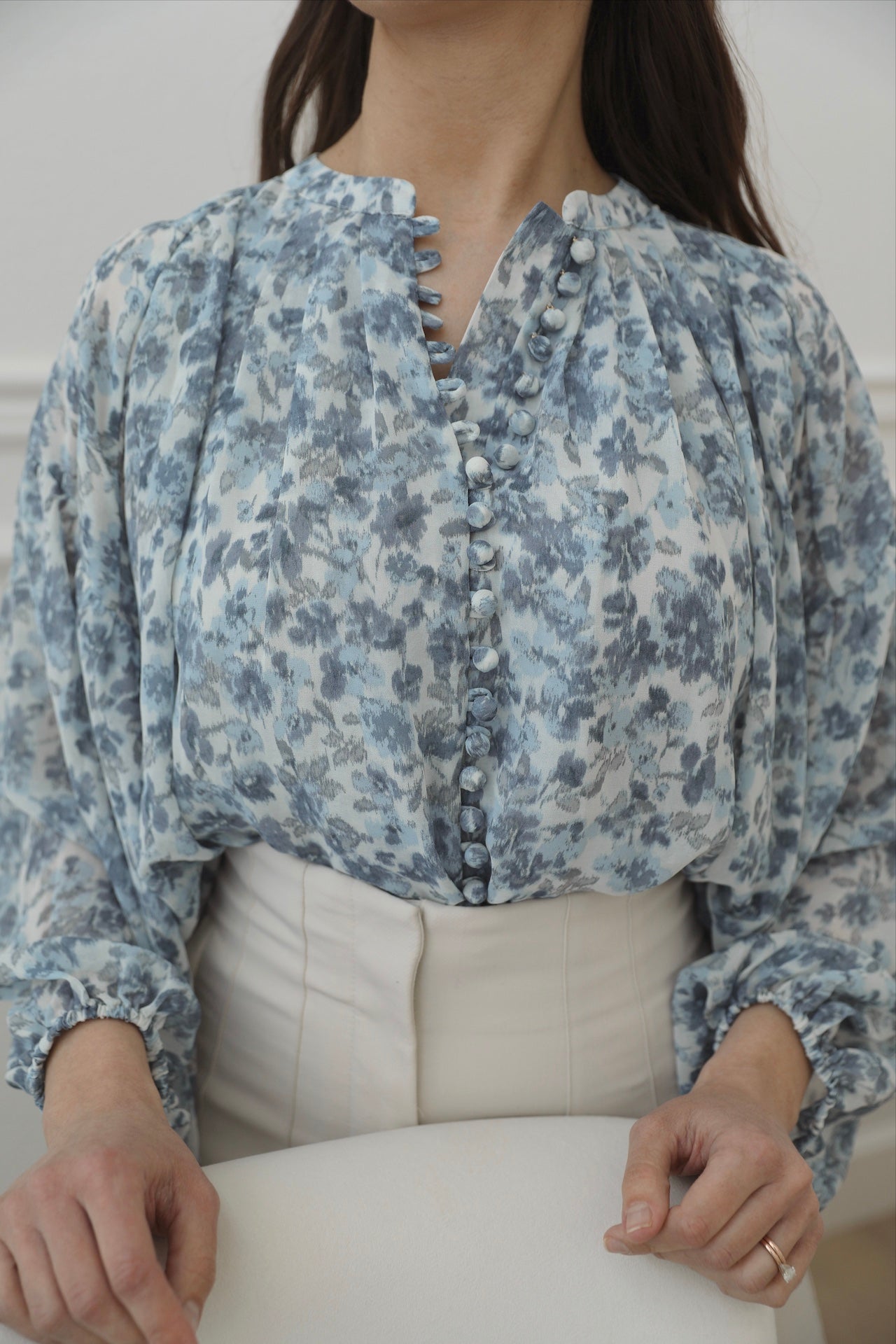blue floral top with long sleeves and front fabric buttons