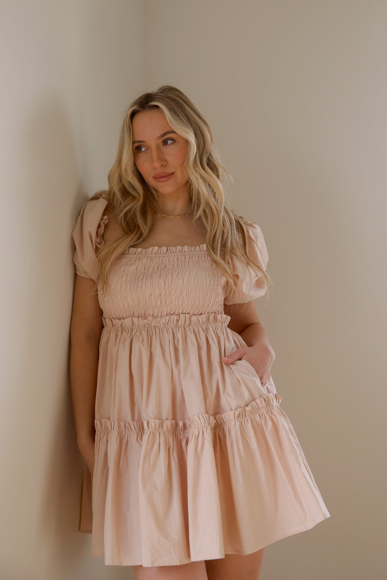 pink babydoll tiered mini dress with puff sleeves and smocked bodice
