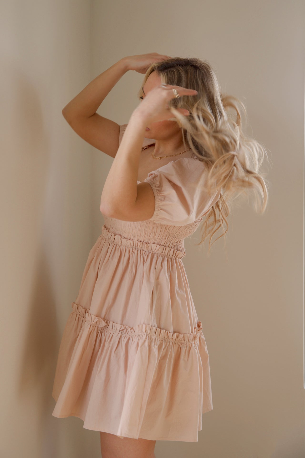 pink babydoll tiered mini dress with puff sleeves and smocked bodice