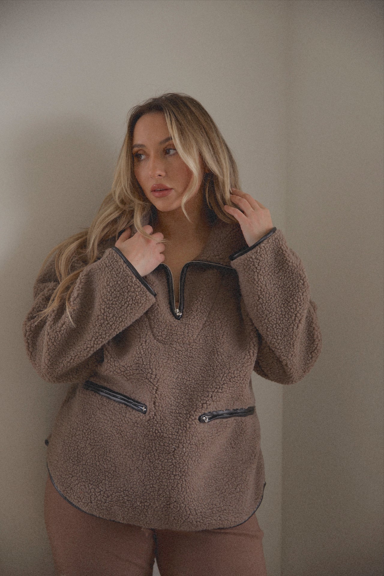 brown sherpa teddy sweater with black leather piping