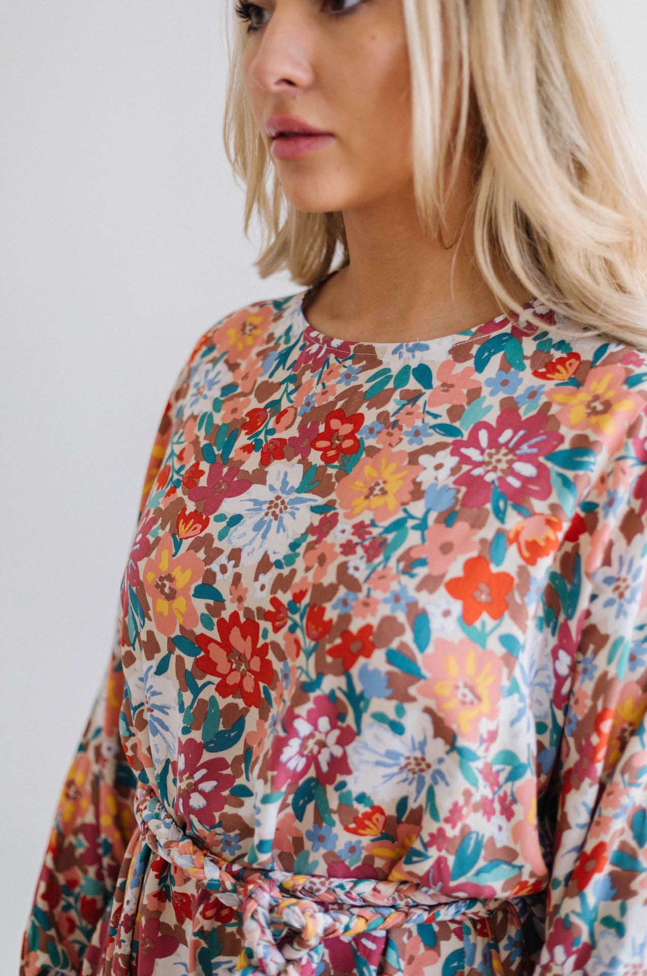 multicolor floral print dress with long sleeves and braided belt