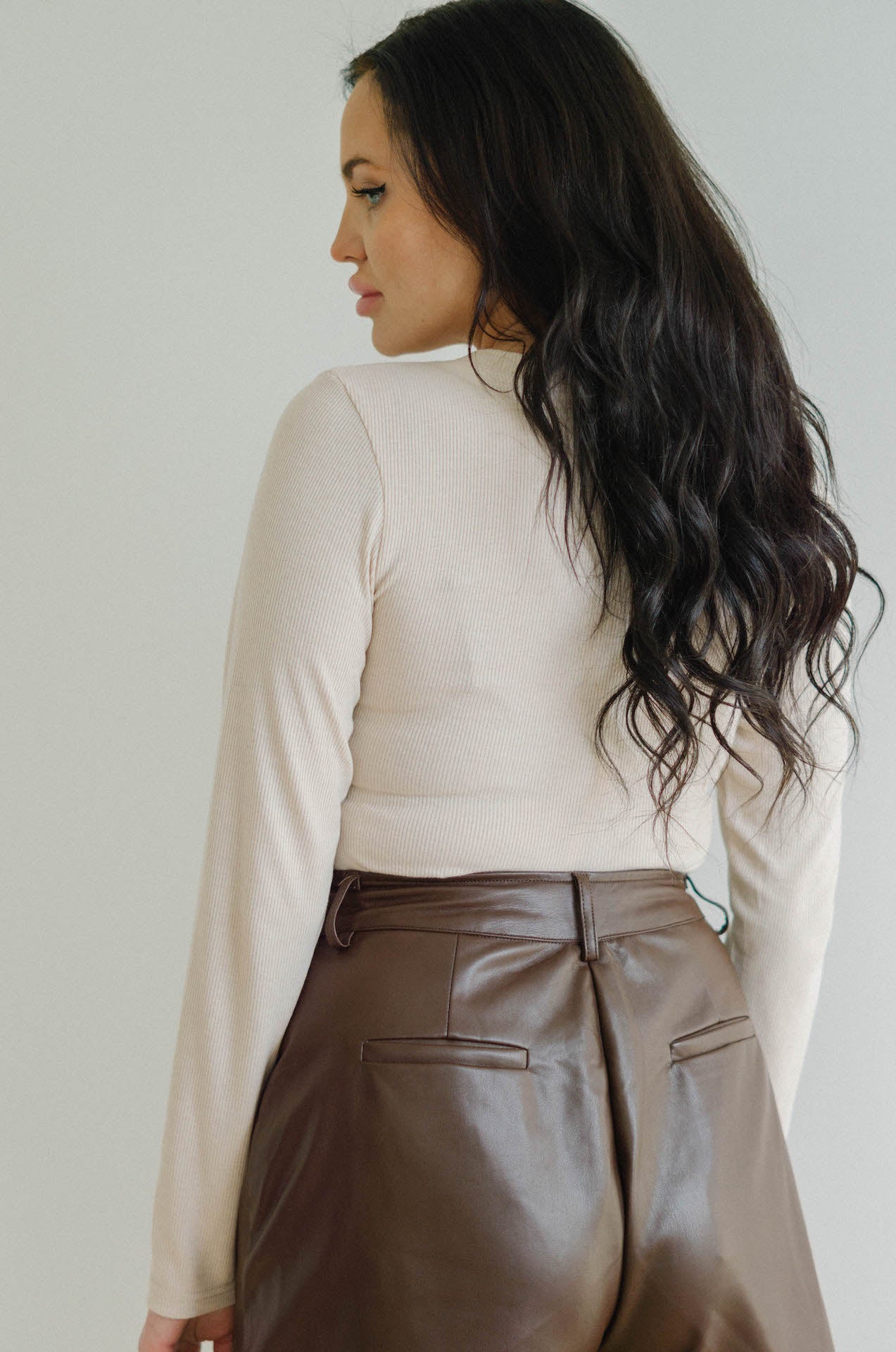long sleeve bodysuit with brown leather shorts