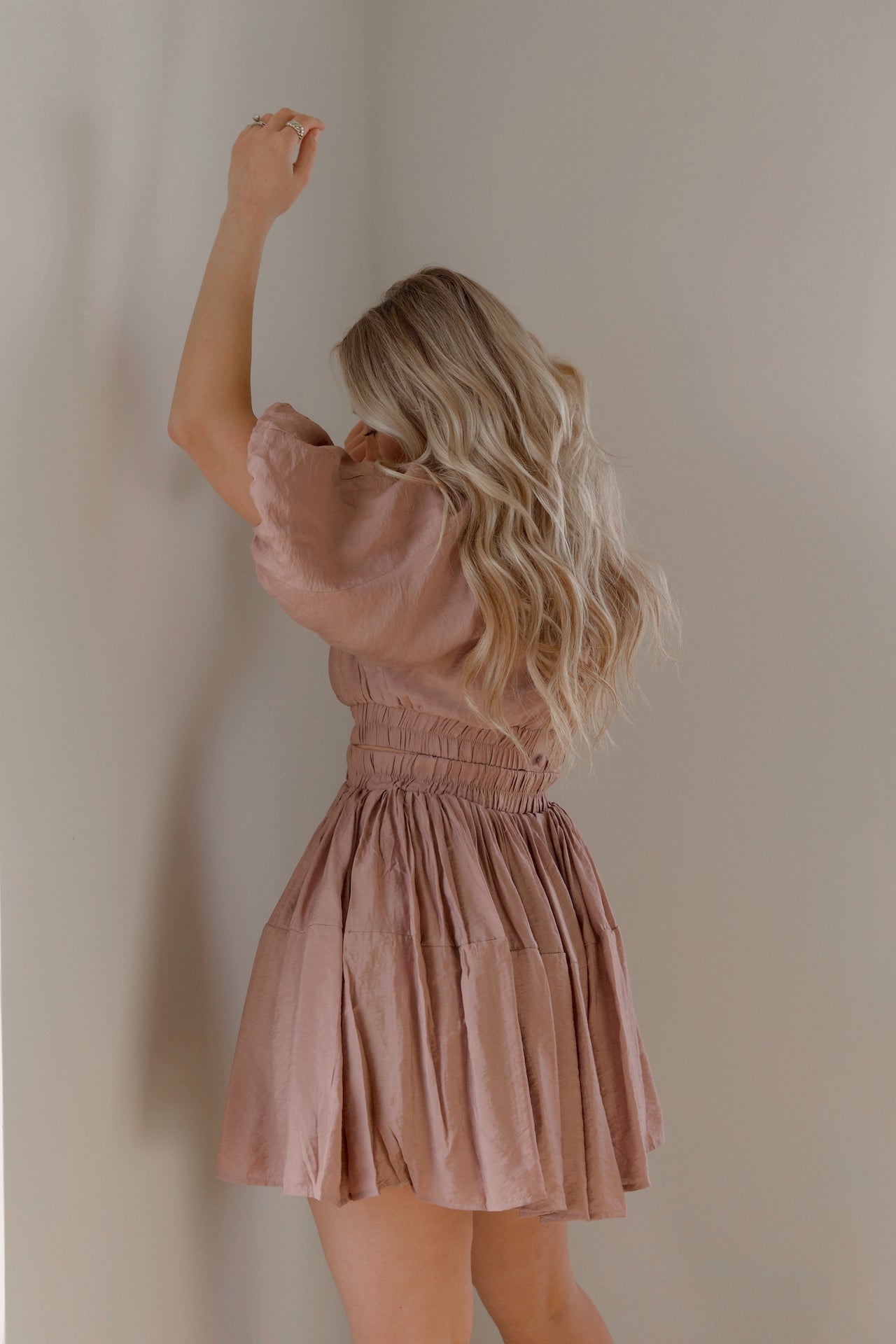 dusty mauve cut out mini dress with puff sleeves and an elastic waist