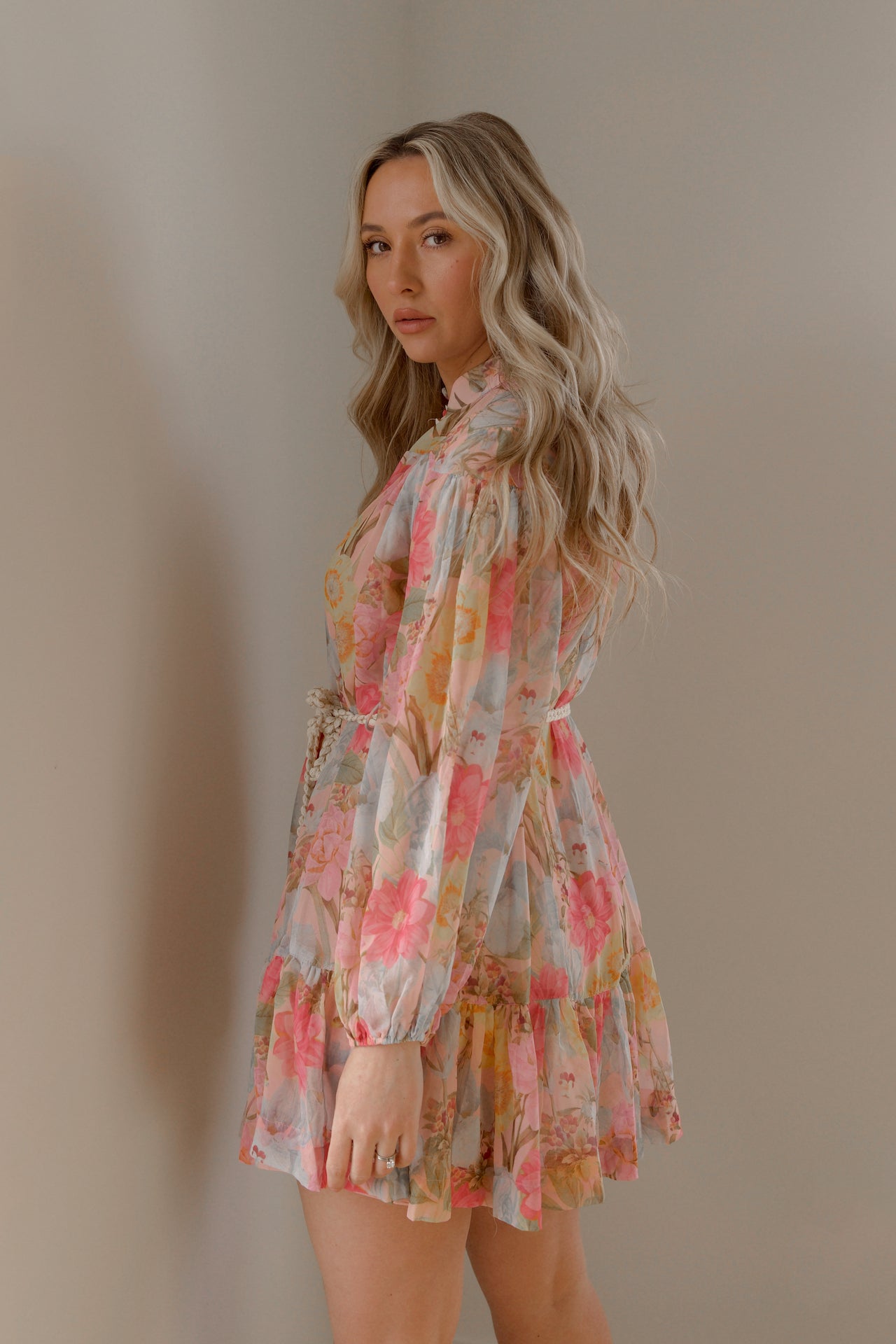 pink and blue floral sheer mini dress with long sleeves and a braided waist tie