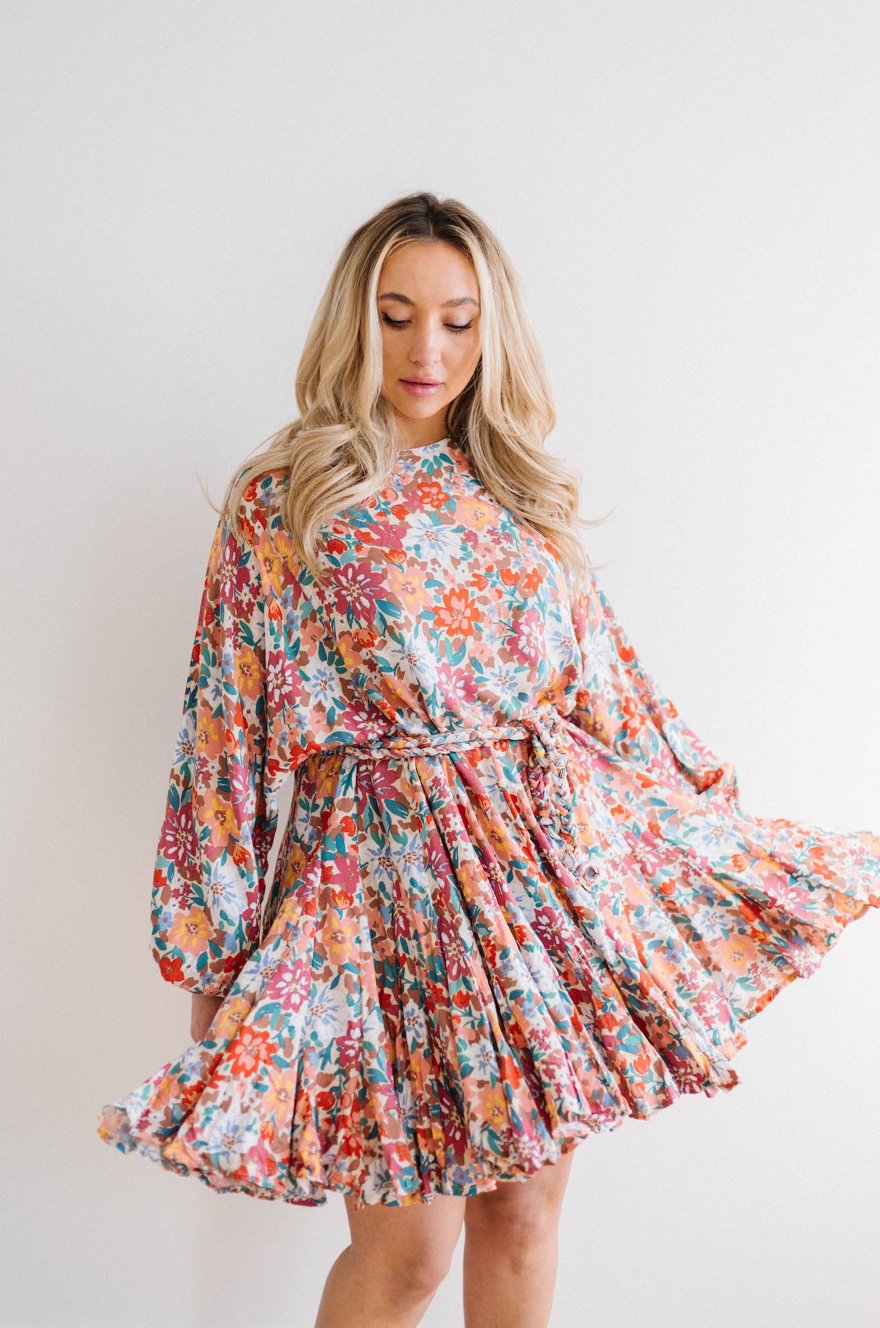 multicolor floral print dress with long sleeves and braided belt