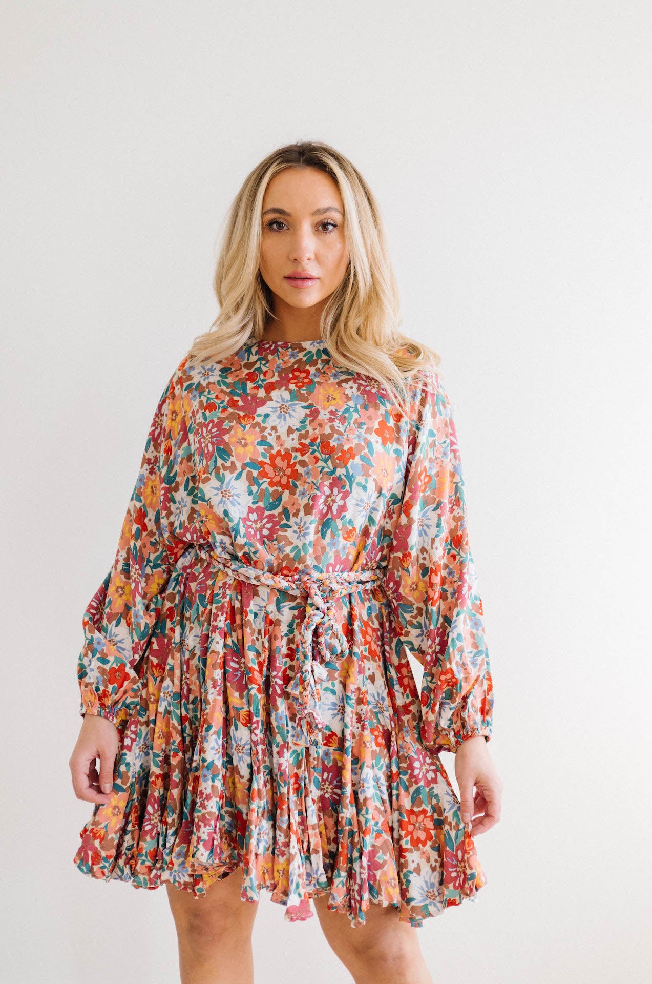 multicolor floral print dress with long sleeves and braided belt