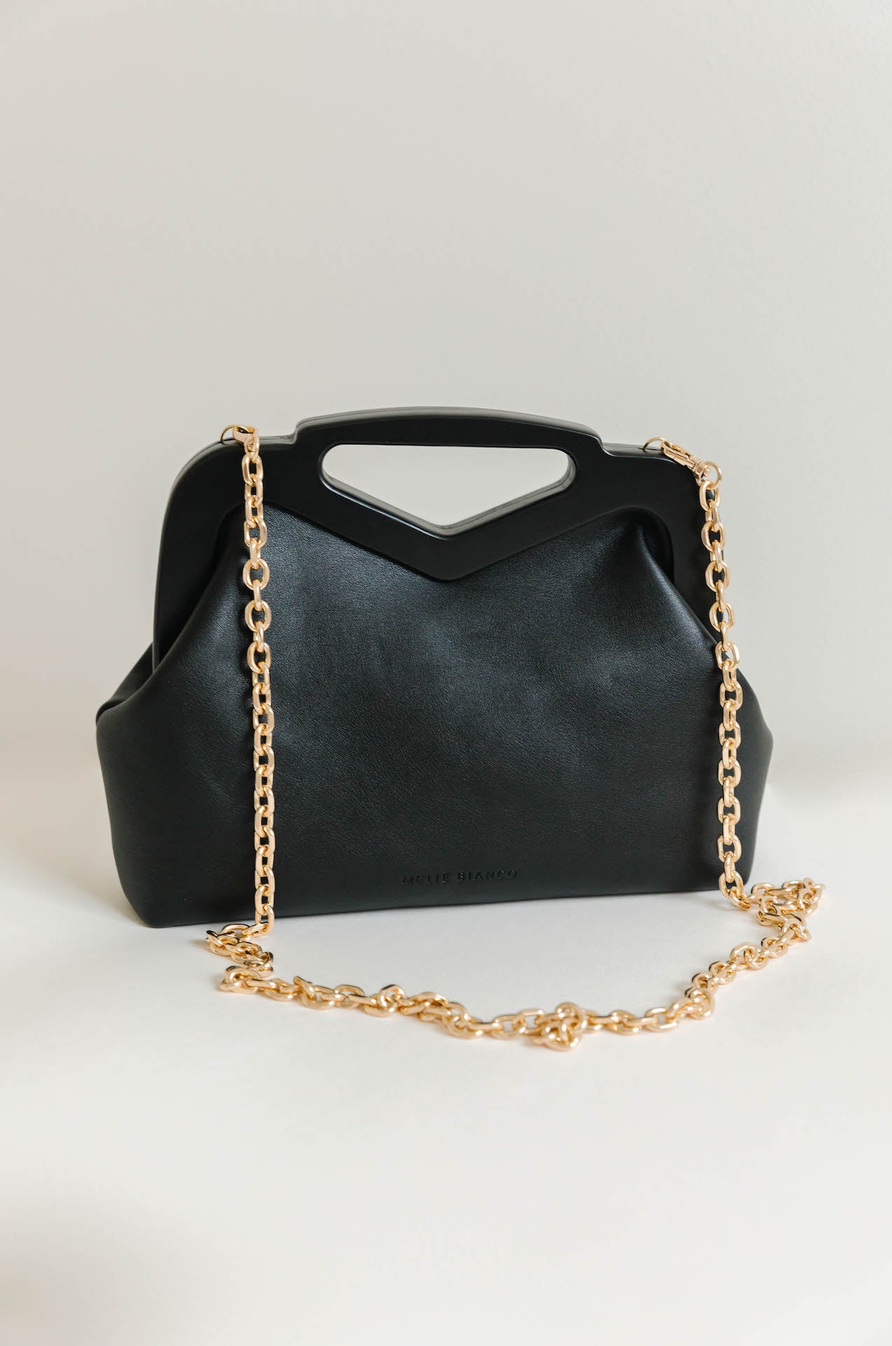 black vegan leather triangle top handle bag