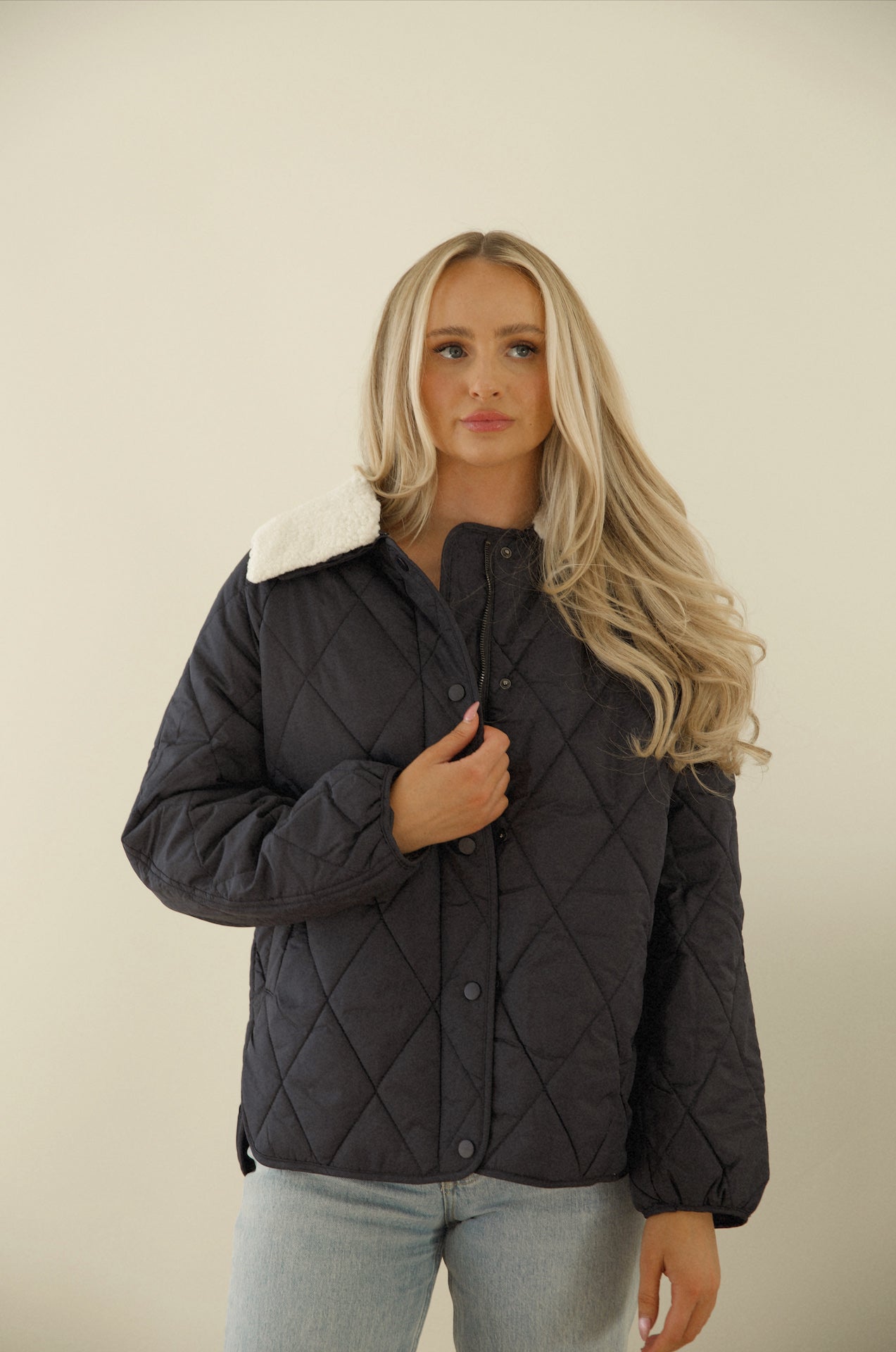 blue quilted puffer jacket with a sherpa collar