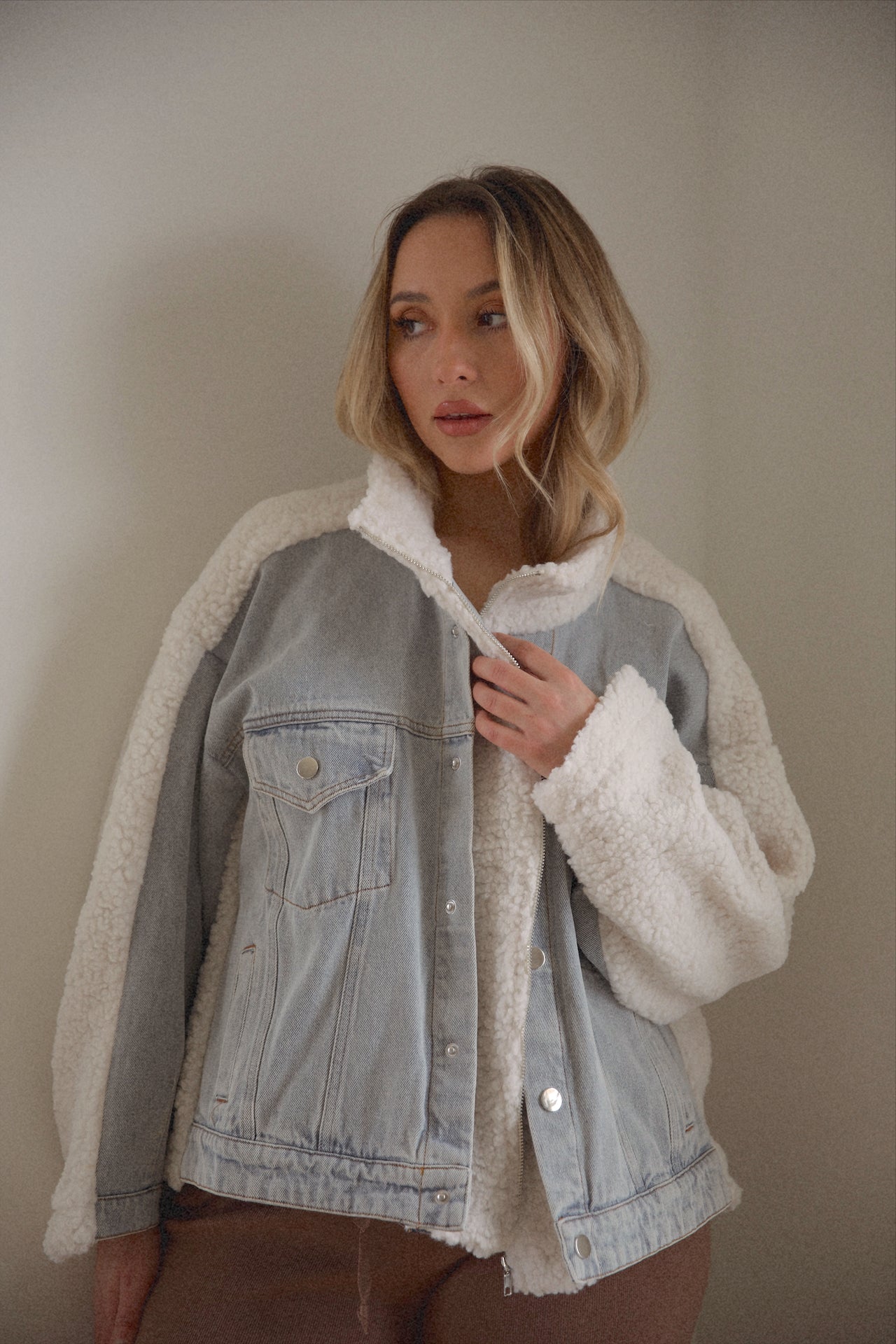 oversized denim jacket with sherpa lining and a zip up denim jacket closure