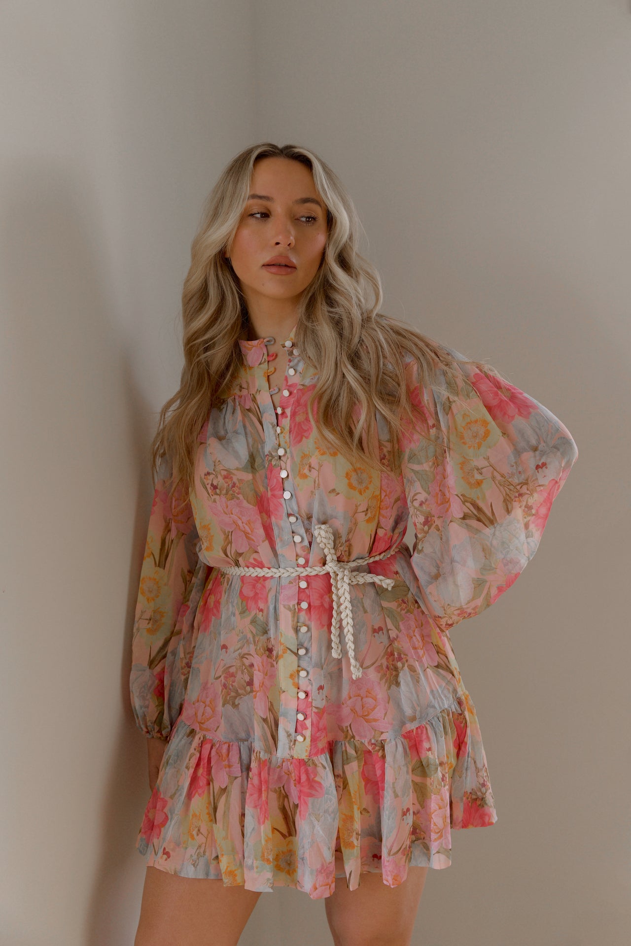 pink and blue floral sheer mini dress with long sleeves and a braided waist tie