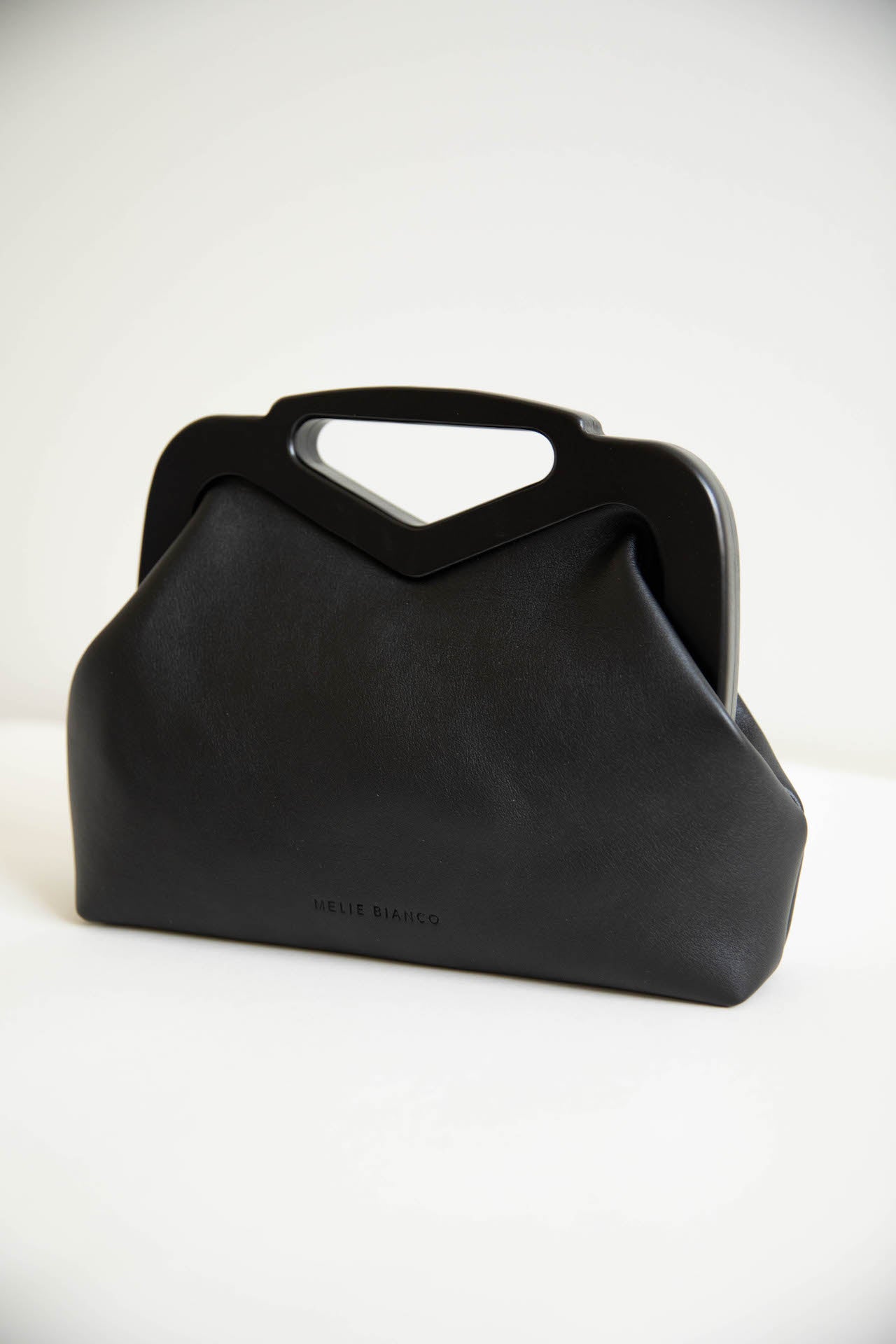 black vegan leather triangle top handle bag