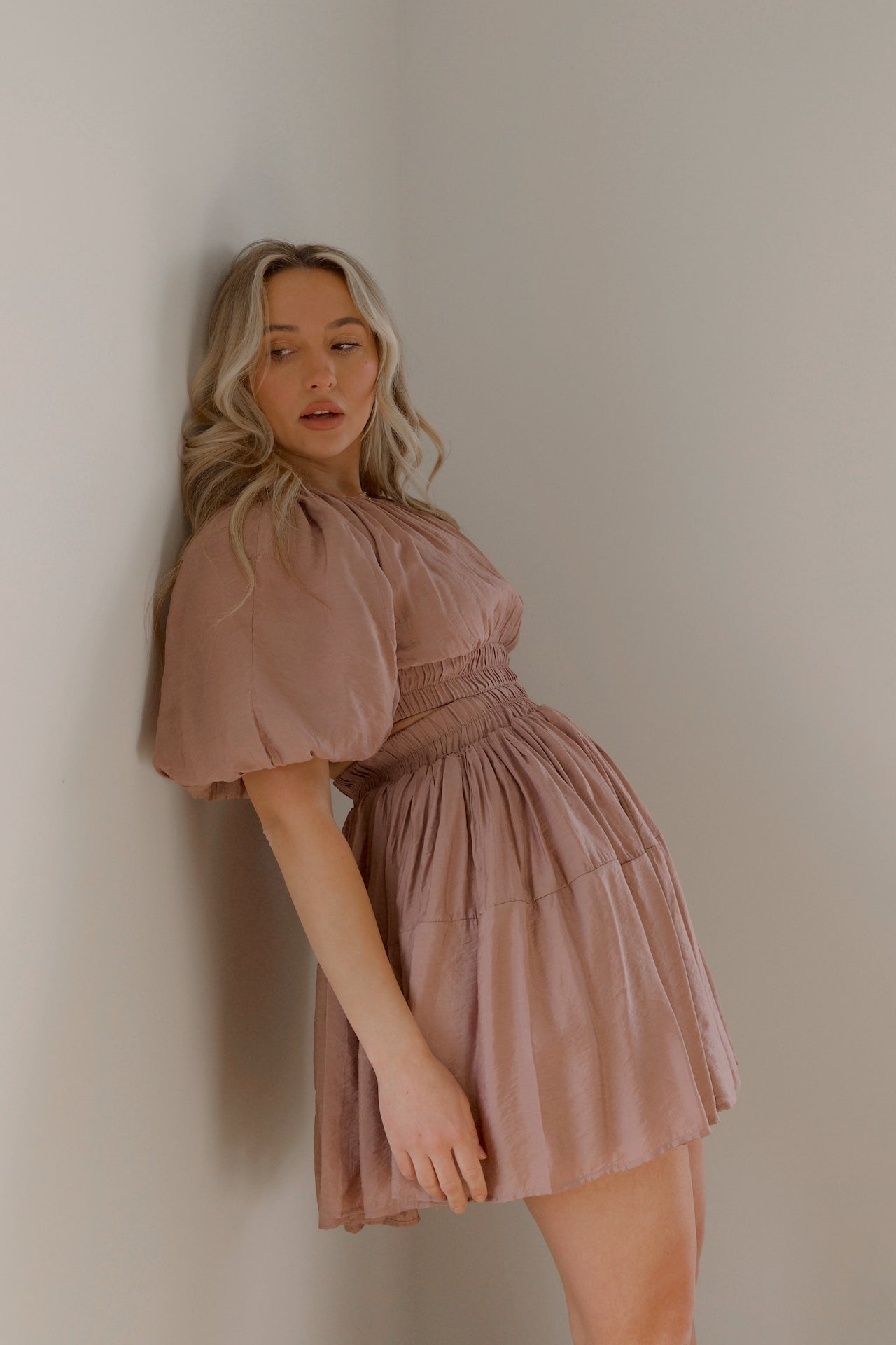 dusty mauve cut out mini dress with puff sleeves and an elastic waist