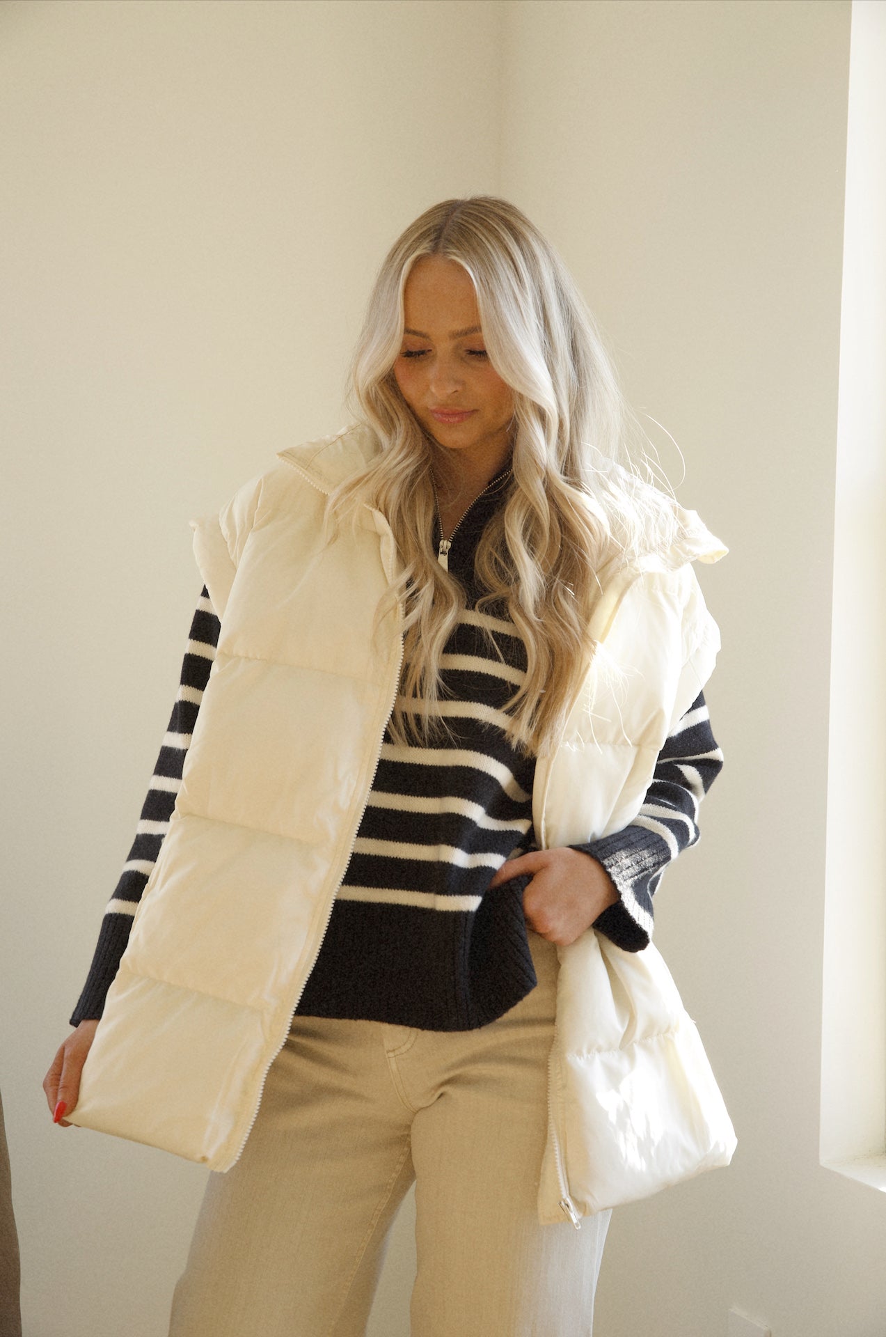 black and white stripe sweater paired with a puffer vest