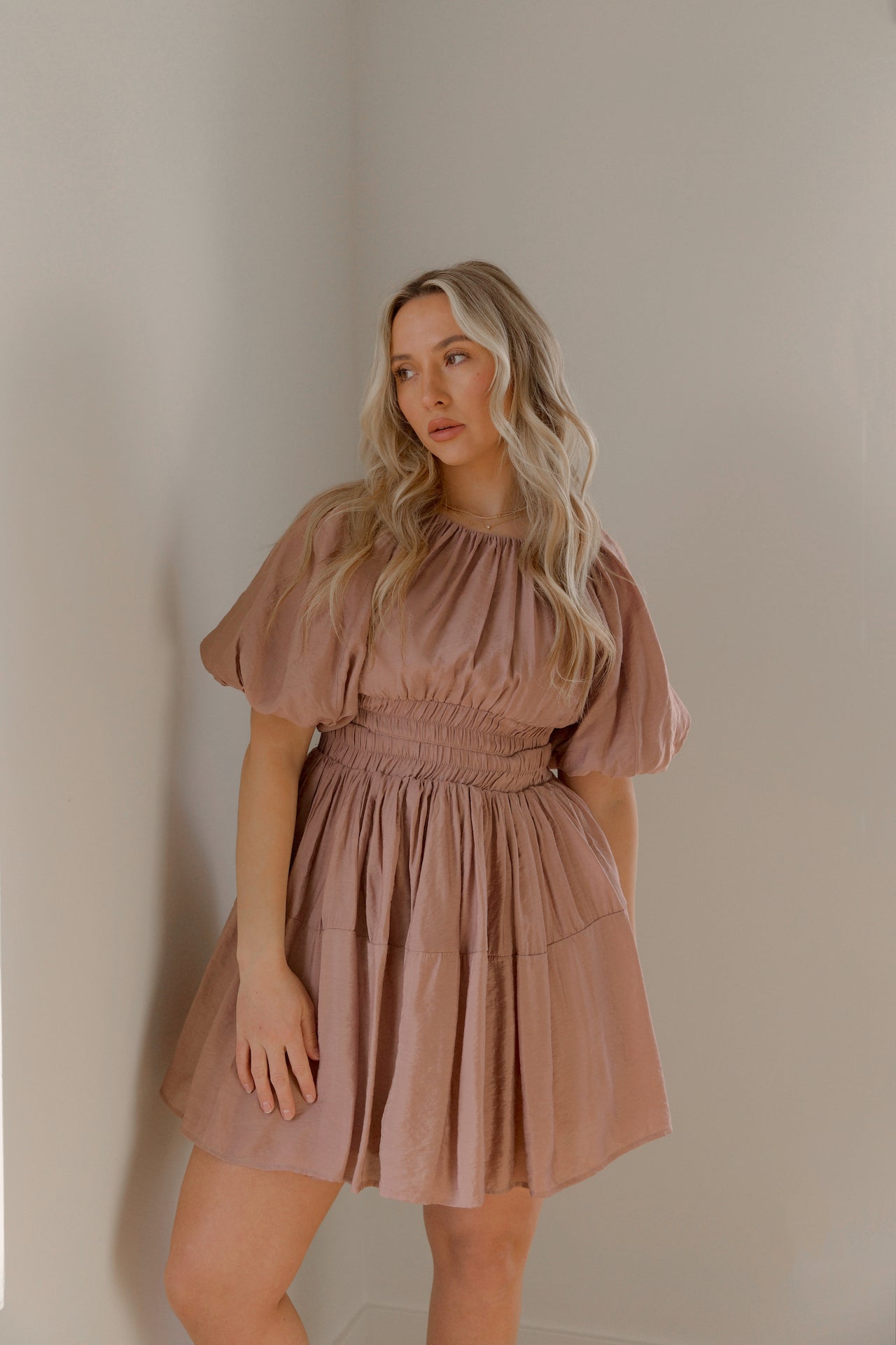 dusty mauve cut out mini dress with puff sleeves and an elastic waist