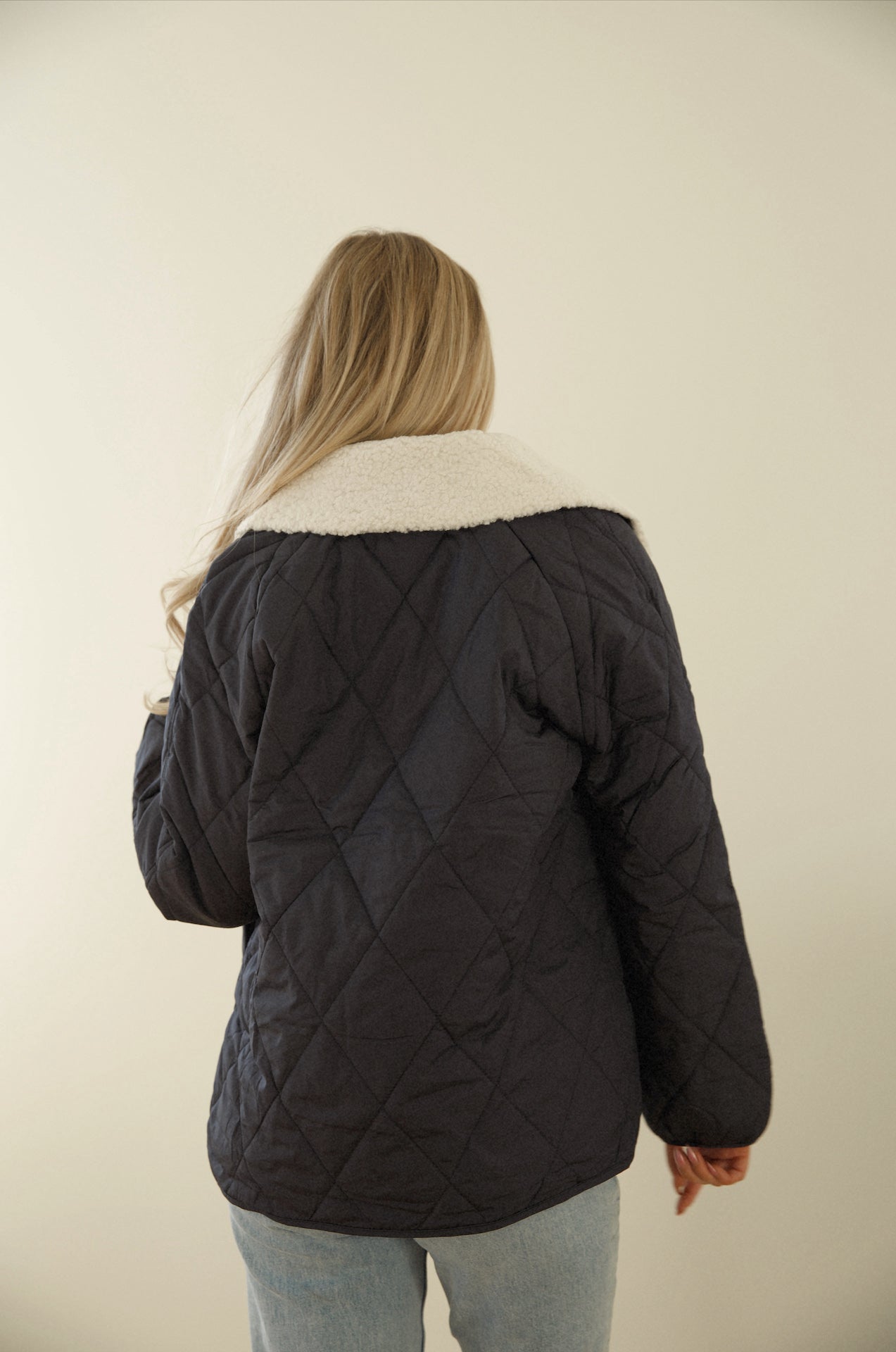 blue quilted puffer jacket with a sherpa collar