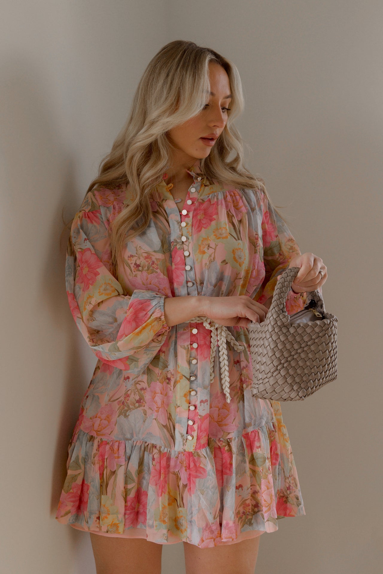 pink and blue floral sheer mini dress with long sleeves and a braided waist tie