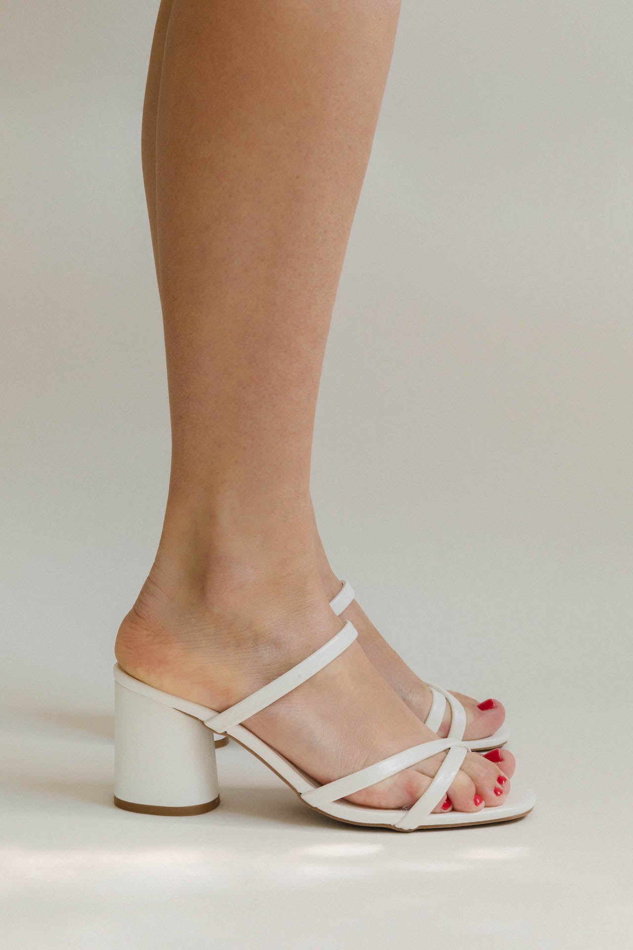 white strappy heel sandals with a low chunky block heel